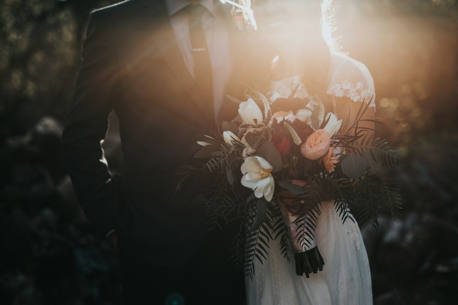 Groom beside bride holding a bouquet