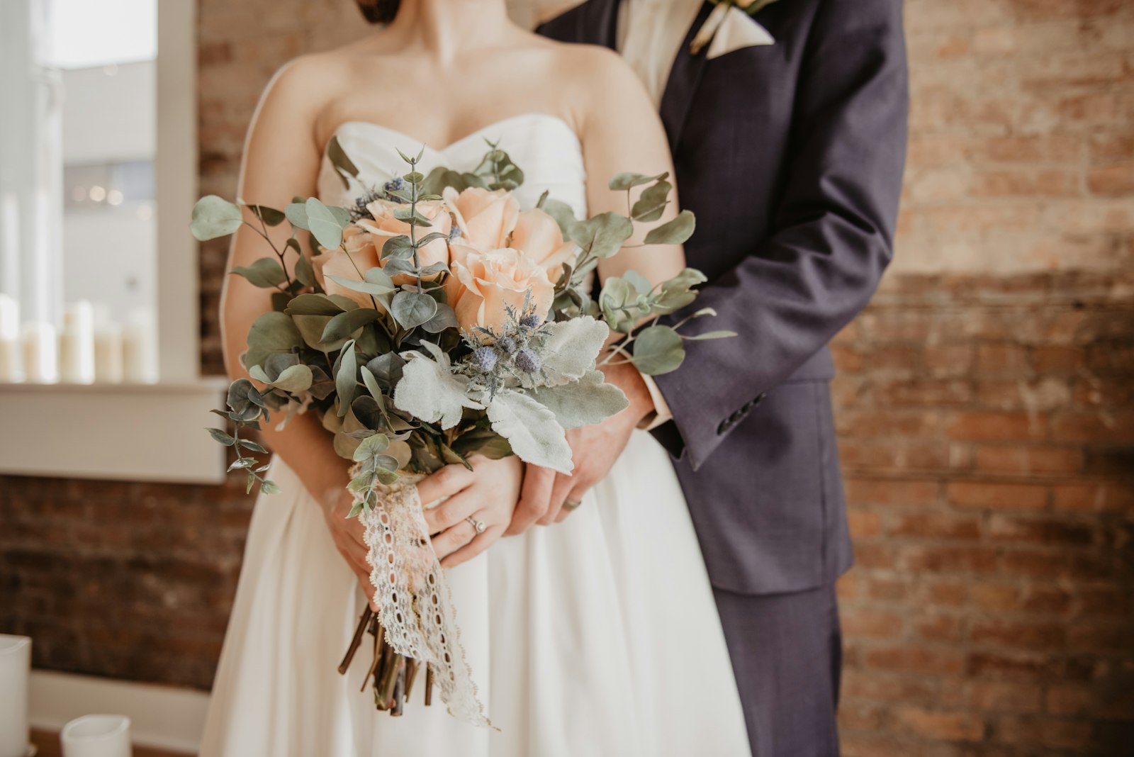 Bride holding a bouquet of pale flowers